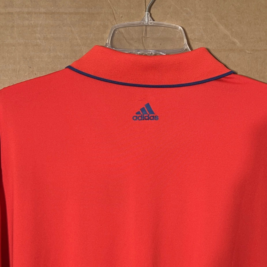 Adidas Puremotion men’s reddish orange polo shirt.