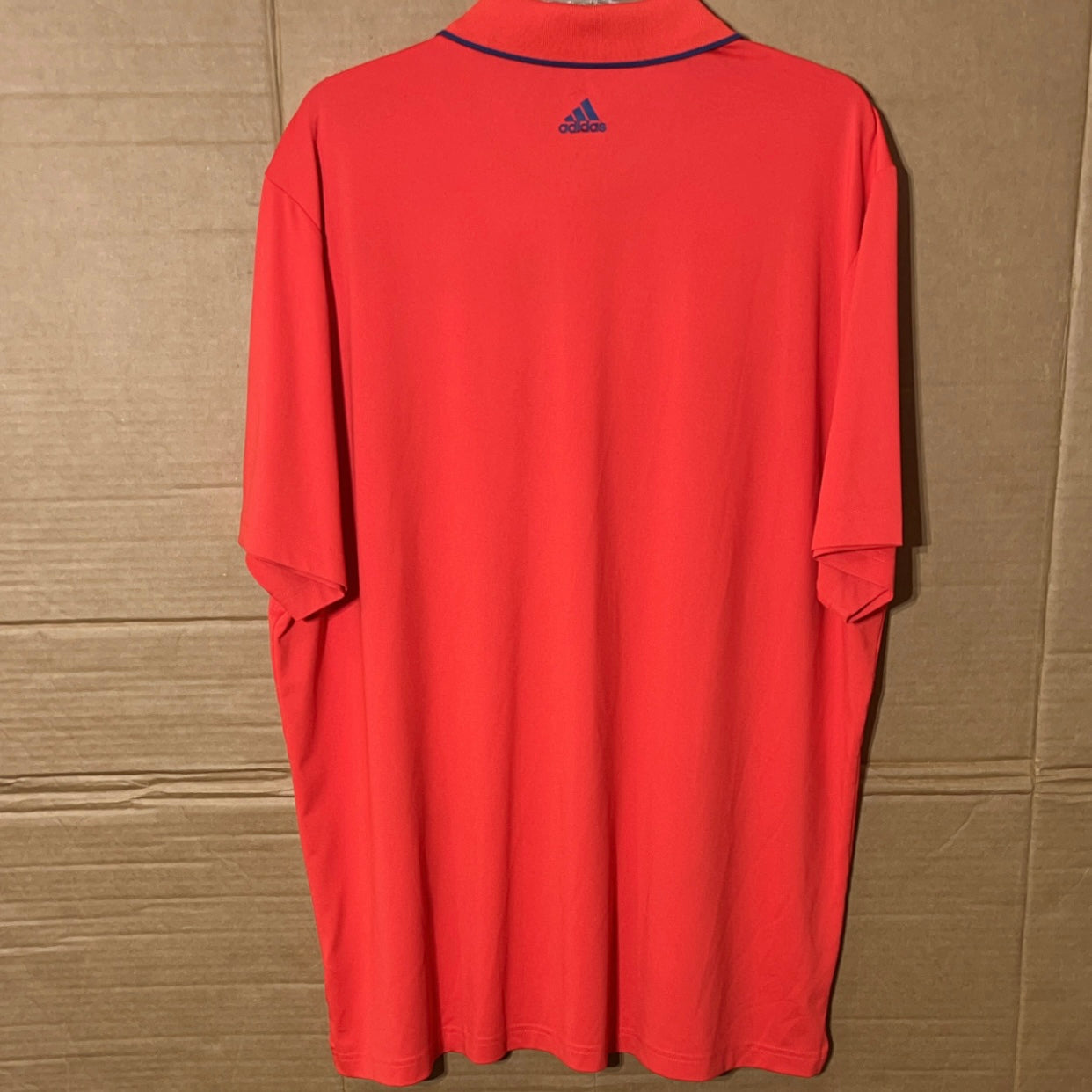 Adidas Puremotion men’s reddish orange polo shirt.