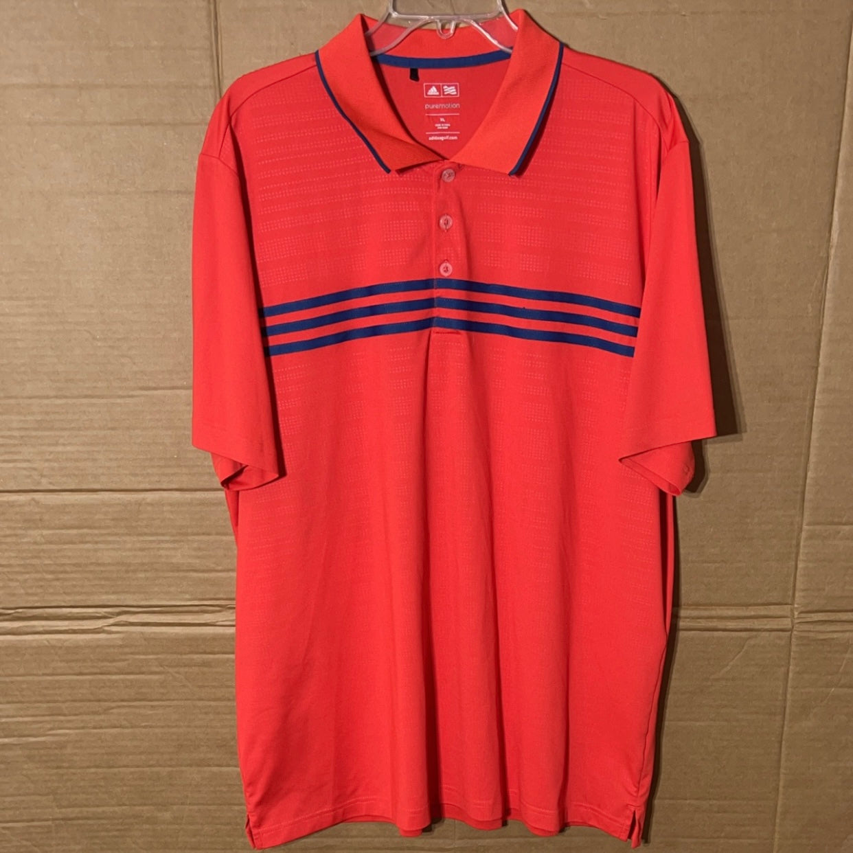 Adidas Puremotion men’s reddish orange polo shirt.